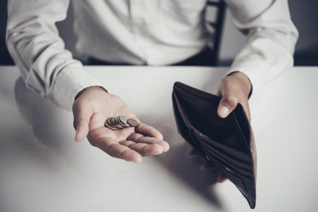 businessman saving money,Man carrying a wallet in hand, the doll